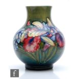 William Moorcroft - A vase of globe and shaft form decorated in the Frilled Orchid pattern with