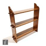 Unknown - An oak open fronted three tier bookcase with exposed tenon joints in the Arts and Crafts