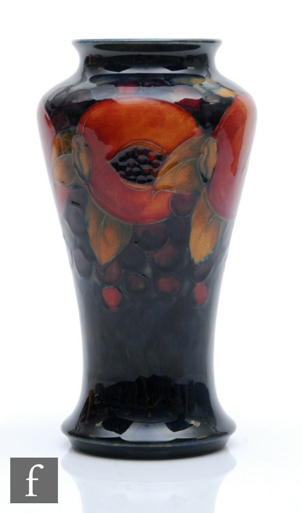 William Moorcroft - A vase of tapering form decorated in the Pomegranate pattern with a band of open