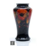William Moorcroft - A vase of tapering form decorated in the Pomegranate pattern with a band of open
