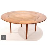 Dyrlund - Danish - A teak Flip-Flap Lotus extending circular dining table, with pull-out hinged