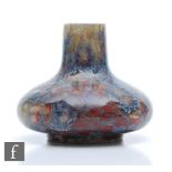 Ruskin Pottery - A high fired vase of compressed form decorated with a snakeskin type glaze in tones