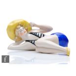 Unknown - A German Art Deco porcelain 'Bathing Beauty' figure, modelled as a reclining lady figure