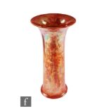Ruskin Pottery - A large trumpet vase decorated in an all over orange lustre, impressed mark and