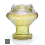 Loetz - An early 20th Century glass vase of footed sleeve form with a swollen upper body and triform