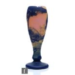 Devez - An early 20th Century cameo glass vase of footed swollen form, cased in blue over peach
