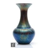 Kralik - An early 20th Century glass vase of low shouldered form with everted collar neck, decorated