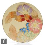 Grays Pottery - A 1930s Art Deco charger decorated with flowers and foliage against a pale yellow