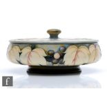 William Moorcroft - A large bowl and cover decorated in the Celadon Leaf and Berry pattern,