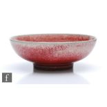 Ruskin Pottery - A small high fired shallow footed bowl decorated in a sang de beouf glaze,