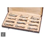 In the manner of Christofle - A cased set of twelve French 1930s Art Deco cast metal knife rests