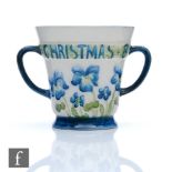 William Moorcroft - James Macintyre & Co - A small twin handled loving cup decorated with blue