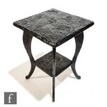 Liberty & Co - An Aesthetic foliate carved two-tier softwood occasional table of square form, raised