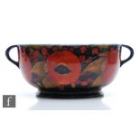 William Moorcroft - A large twin handled bowl decorated in the Pomegranate pattern with open and