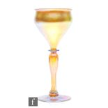 Louis Comfort Tiffany - An early 20th Century drinking glass with ogee bowl with basal bladed knop