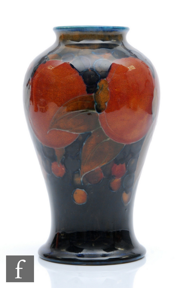 William Moorcroft - A vase of tapering form with a squat collar neck decorated in the Pomegranate