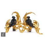 A pair of 19th Century gilt chenets each mounted with bronze amorini, one holding a birds nest the