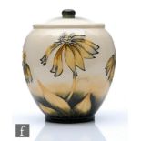 A boxed Moorcroft Pottery vase and cover decorated in the Coneflower pattern designed by Anji