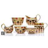Six pieces of assorted Royal Crown Derby comprising three sugar bowls and three cream/milk jugs of