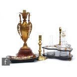 A 19th Century gilt metal table lamp in the form of a Grecian urn on red serpentine base, height