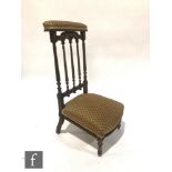 A Victorian carved walnut prie dieu or prayer chair, the carved fluted back over lozenge pattern