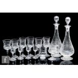 A pair of Stevens & Williams clear crystal decanters circa 1910, the slender bottle form body with