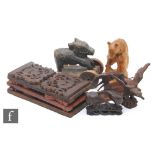 Three various carved wooden book tidies and five carved animal figures including a naive carved