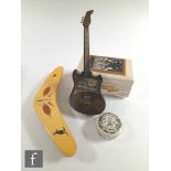 A novelty musical base guitar in black plastic with stand, an Elvis Presley musical cigarette box, a