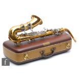 A British made brass saxophone by Lafleur London, with mouth piece, in plush lined case, width 59cm.