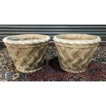 A pair of composite stone tub planters each of lattice design and tapering form, heights 32cm. (2)