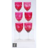 A set of six ruby cased and flash cut wine glasses, the bowls flash cut through to clear crystal