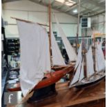 A 1940s or later model pond yacht on wooden stand with beam, length 74cm, a similar single masted