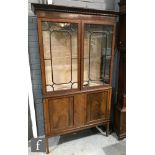 An Edwardian mahogany Chippendale style display cabinet enclosed by a pair of bar glazed doors below