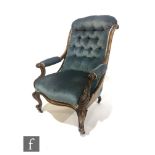 A Victorian carved walnut scroll buttoned back easy elbow chair, on carved cabriole legs,