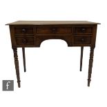 A small 19th Century George IV mahogany kneehole writing table or dressing table, fitted with five