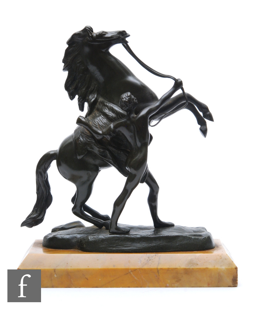 A small 20th Century bronze of a Marley horse with attendant holding reigns, on veined marble