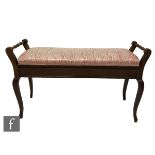 An Edwardian walnut duet stool on cabriole legs below a lift up seat upholstered in pink damask,