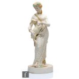 A large 19th Century W.H Goss Parian figure of a scantily clad female holding a kid goat with her