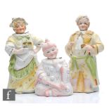 Three 19th Century bisque nodding figures comprising a lady and gentleman, she holding a cup of tea,