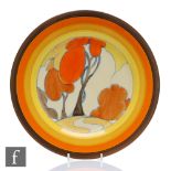 A large Clarice Cliff circular plate circa 1932, hand painted in the Orange Autumn pattern with a
