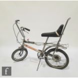 A vintage 1970s Raleigh Chopper Mk 2 bicycle, with T bar gear stick, the grey paint with orange