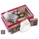 A small collection of 1930s or later wooden printing blocks and a small quantity of coins. (qty)