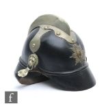 A World War One German Imperial black leather fire brigade helmet with plated comb, star and