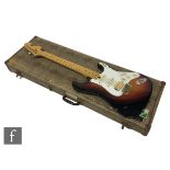 A vintage Stratocaster style guitar, in sunburst with maple neck, back plate numbered 97/0, in