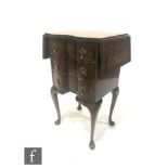 A small George I style walnut three drawer drop flap bedside table fitted with brass pear drop