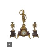 A late 19th Century French gilt painted spelter and rouge marble clock garniture, the eight day