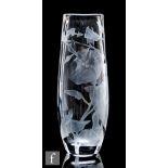 A contemporary clear crystal glass vase of compressed ovoid form, etched with a scrolling