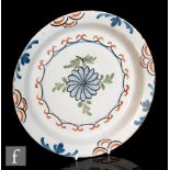 A late 18th to early 19th Century English tin glazed plate with polychrome decoration, unmarked,