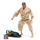 A Palitoy Action Man figure wearing Judo outfit, circa 1970, the painted hair figure with Judogi (