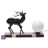 A 20th Century table lamp, decorated with a patinated spelter study of a stylised standing stag,